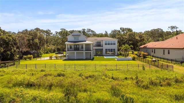 7706 Ficquette Rd, Windermere, FL 34786 - back of property with a balcony, a fenced backyard, and a metal roof