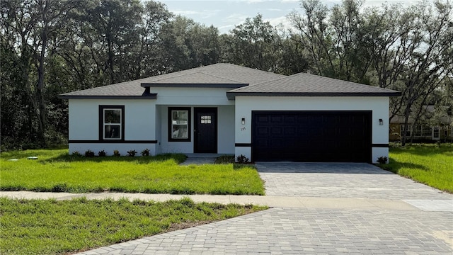 285 Marion Oaks Crse, Ocala, FL 34473 - view of front of house with stucco siding, a front yard, an attached garage, decorative driveway, and roof with shingles