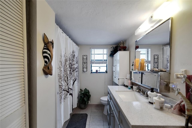 2826 NE 7th St, Ocala, FL 34470 - bathroom with vanity, toilet, tile patterned floors, a textured ceiling, and a shower with curtain