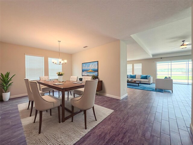 4632 Egg Harbor Dr, Kissimmee, FL 34746 - dining room with a chandelier, dark wood-style flooring, baseboards, and ceiling fan