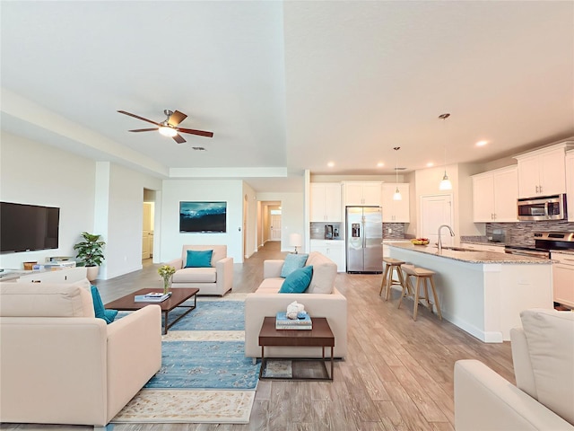 4632 Egg Harbor Dr, Kissimmee, FL 34746 - living room featuring light wood-type flooring, ceiling fan, and recessed lighting