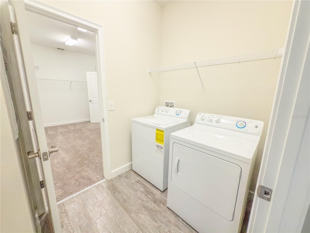 4632 Egg Harbor Dr, Kissimmee, FL 34746 - laundry area with separate washer and dryer, light wood-style floors, and baseboards