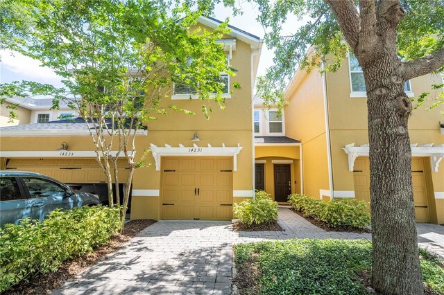 14231 Desert Haven St Unit Ge, Windermere, FL 34786 - multi unit property with stucco siding, an attached garage, and decorative driveway