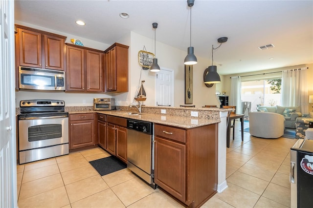 14231 Desert Haven St Unit Ge, Windermere, FL 34786 - kitchen featuring stainless steel appliances, a peninsula, open floor plan, light tile patterned floors, and recessed lighting