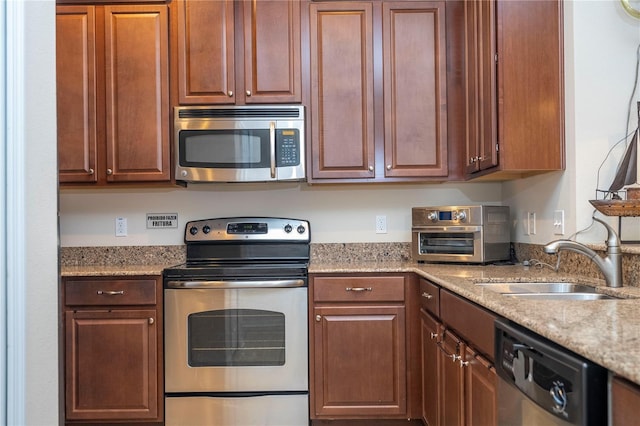 14231 Desert Haven St Unit Ge, Windermere, FL 34786 - kitchen with appliances with stainless steel finishes, a sink, and light stone countertops