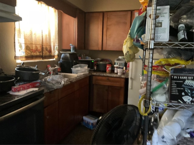 58 W 27th St Unit N, West Palm Beach, FL 33404 - kitchen with under cabinet range hood, electric stove, brown cabinets, and a sink