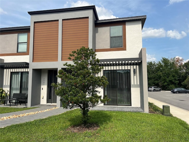 3301 Tranquil Trl, Kissimmee, FL 34747 - view of front of house with stucco siding and a front yard