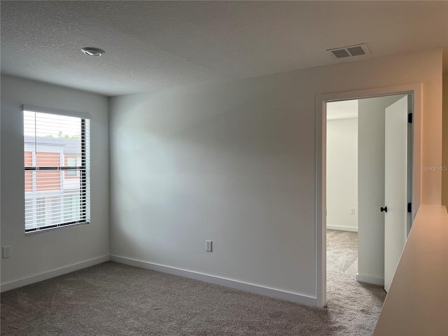 3301 Tranquil Trl, Kissimmee, FL 34747 - empty room featuring light carpet, a textured ceiling, and baseboards