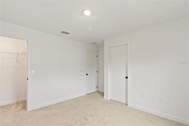 3301 Tranquil Trl, Kissimmee, FL 34747 - unfurnished bedroom with light colored carpet and a spacious closet