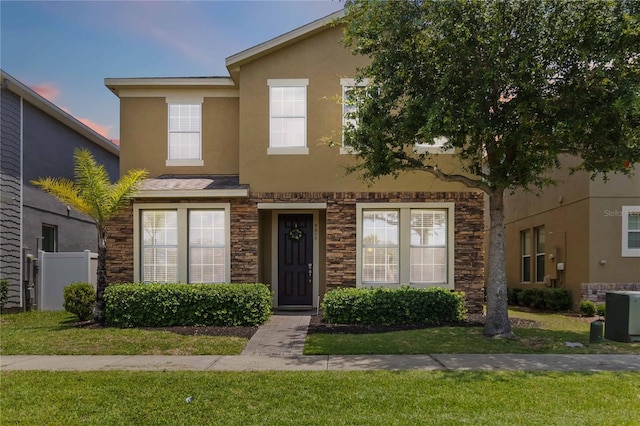 5217 Creekside Park Ave, Orlando, FL 32811 - view of property with stone siding, stucco siding, and a front yard