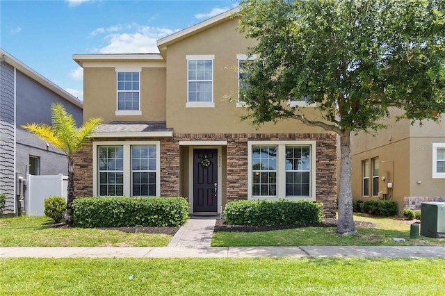 5217 Creekside Park Ave, Orlando, FL 32811 - townhome / multi-family property featuring stone siding and stucco siding