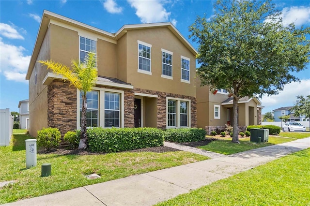 5217 Creekside Park Ave, Orlando, FL 32811 - view of front of house with stone siding, stucco siding, and a front yard