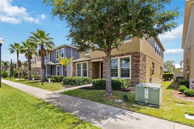5217 Creekside Park Ave, Orlando, FL 32811 - view of front of property featuring stone siding, a front lawn, and stucco siding