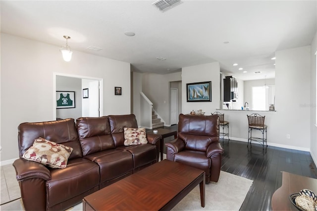 5217 Creekside Park Ave, Orlando, FL 32811 - living area with baseboards, dark wood finished floors, stairway, and recessed lighting