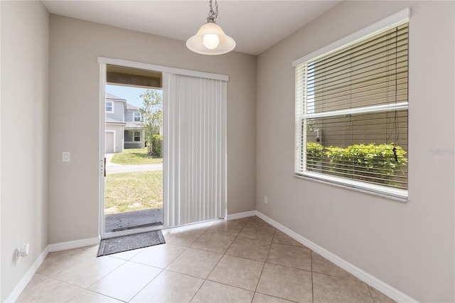5217 Creekside Park Ave, Orlando, FL 32811 - doorway to outside with baseboards and light tile patterned floors