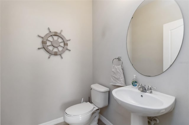 5217 Creekside Park Ave, Orlando, FL 32811 - bathroom featuring toilet, a sink, and baseboards