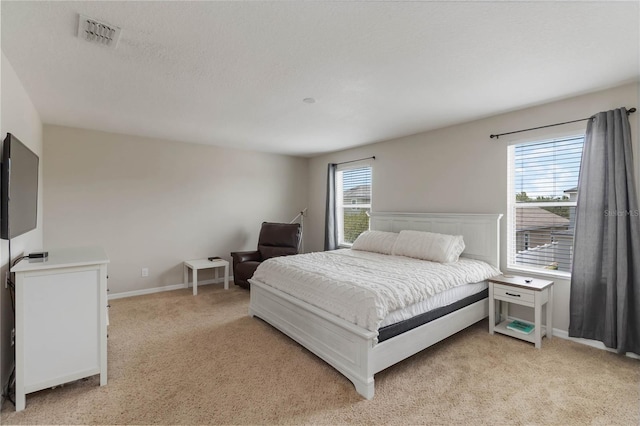 5217 Creekside Park Ave, Orlando, FL 32811 - bedroom featuring multiple windows and light carpet