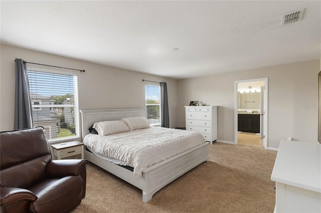 5217 Creekside Park Ave, Orlando, FL 32811 - bedroom with light colored carpet, connected bathroom, and baseboards