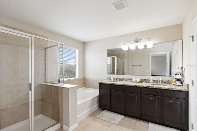 5217 Creekside Park Ave, Orlando, FL 32811 - bathroom with a shower stall, a garden tub, tile patterned floors, and double vanity