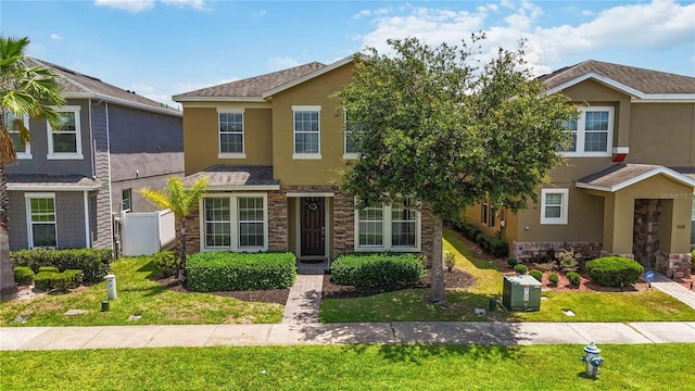 5217 Creekside Park Ave, Orlando, FL 32811 - view of property with stucco siding, stone siding, and a front lawn