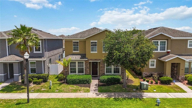 5217 Creekside Park Ave, Orlando, FL 32811 - view of property featuring stucco siding, stone siding, and a front yard