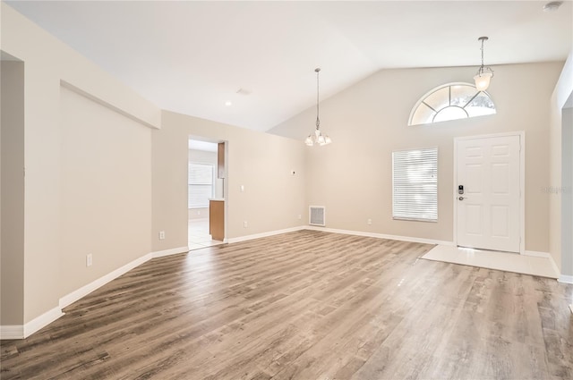 4305 Balmoral Ct, Wesley Chapel, FL 33543 - entryway featuring wood finished floors, a chandelier, baseboards, and high vaulted ceiling