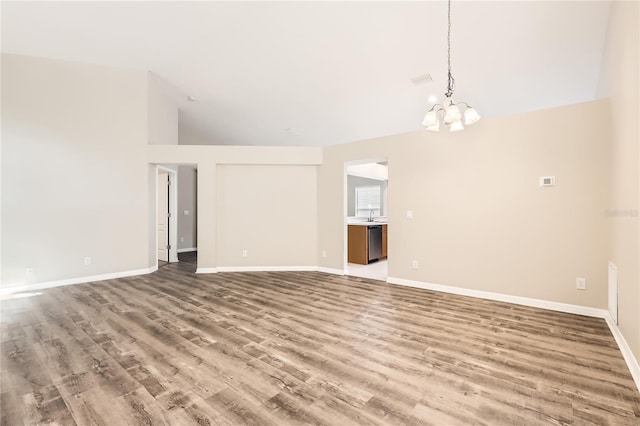 4305 Balmoral Ct, Wesley Chapel, FL 33543 - empty room with wood finished floors, a chandelier, baseboards, and high vaulted ceiling