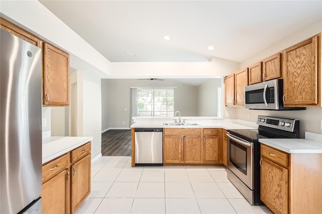 4305 Balmoral Ct, Wesley Chapel, FL 33543 - kitchen with appliances with stainless steel finishes, a sink, light countertops, a peninsula, and light tile patterned flooring