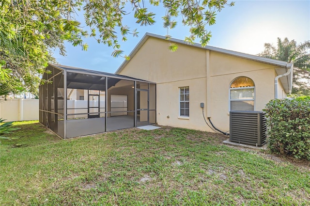4305 Balmoral Ct, Wesley Chapel, FL 33543 - rear view of house featuring cooling unit, stucco siding, and a sunroom