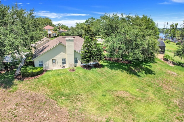 11602 Graces Way, Clermont, FL 34711 - exterior space with a chimney, a yard, stucco siding, and view of scattered trees