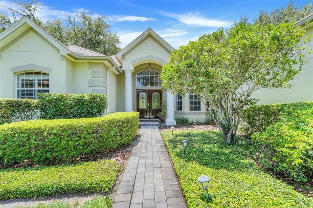 11602 Graces Way, Clermont, FL 34711 - entrance to property featuring stucco siding and french doors