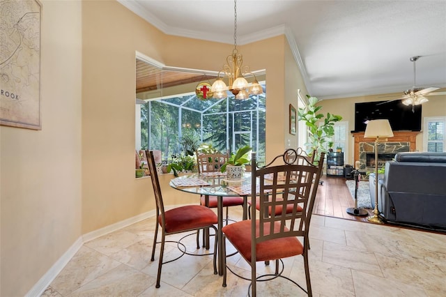 11602 Graces Way, Clermont, FL 34711 - dining room with ornamental molding, ceiling fan, a stone fireplace, baseboards, and a chandelier