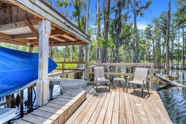 11602 Graces Way, Clermont, FL 34711 - wooden terrace with a water view and view of wooded area