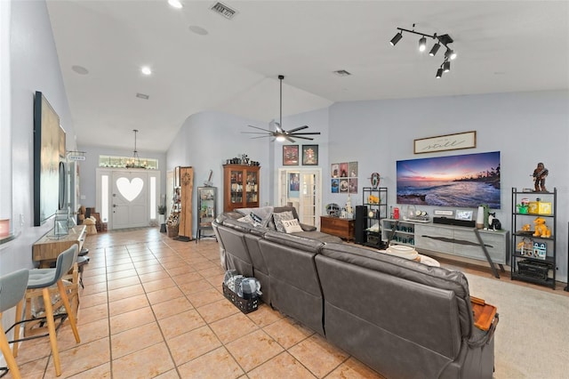 17523 Doris St, Montverde, FL 34756 - living room with vaulted ceiling, a ceiling fan, light tile patterned flooring, and a chandelier