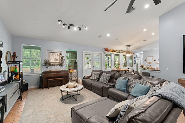 17523 Doris St, Montverde, FL 34756 - living room featuring vaulted ceiling, light tile patterned flooring, recessed lighting, and baseboards