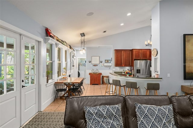 17523 Doris St, Montverde, FL 34756 - living room with vaulted ceiling, light tile patterned floors, recessed lighting, french doors, and a chandelier