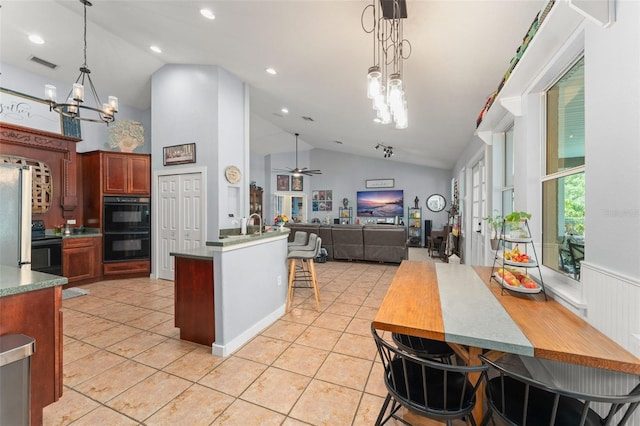 17523 Doris St, Montverde, FL 34756 - kitchen featuring black appliances, a chandelier, lofted ceiling, open floor plan, and light tile patterned floors