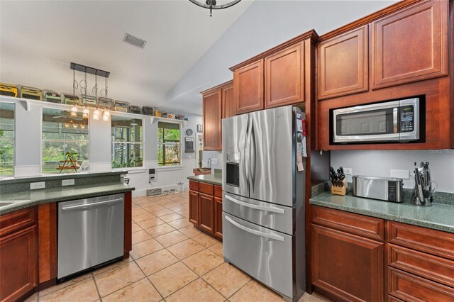 17523 Doris St, Montverde, FL 34756 - kitchen featuring stainless steel appliances, vaulted ceiling, and light tile patterned floors