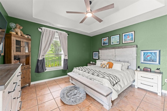 17523 Doris St, Montverde, FL 34756 - bedroom featuring a tray ceiling, baseboards, and light tile patterned floors