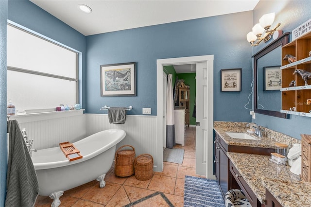 17523 Doris St, Montverde, FL 34756 - bathroom with vanity, a soaking tub, and wainscoting