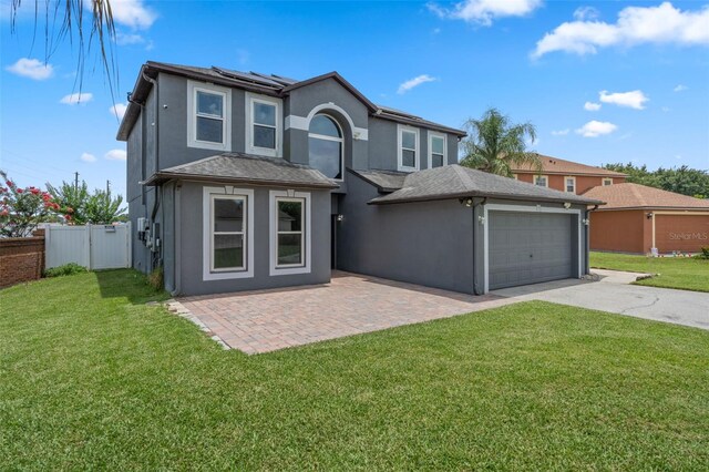 470 Regal Downs Cir, Winter Garden, FL 34787 - traditional-style house featuring roof mounted solar panels, concrete driveway, a garage, and stucco siding