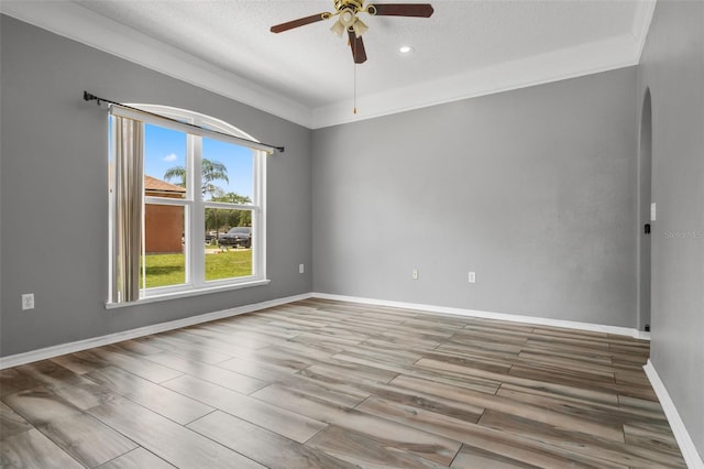 470 Regal Downs Cir, Winter Garden, FL 34787 - empty room with ceiling fan, a textured ceiling, baseboards, wood finished floors, and arched walkways