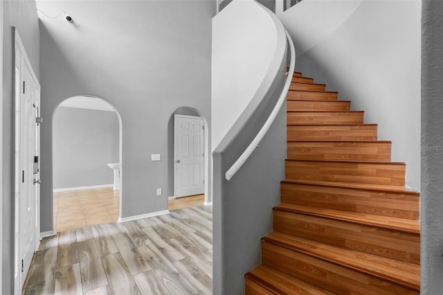 470 Regal Downs Cir, Winter Garden, FL 34787 - stairs with arched walkways, wood finished floors, and baseboards