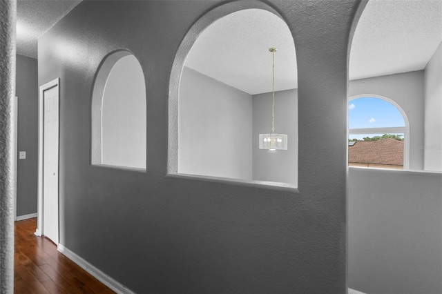 470 Regal Downs Cir, Winter Garden, FL 34787 - hall featuring wood finished floors, a textured ceiling, baseboards, a chandelier, and a textured wall