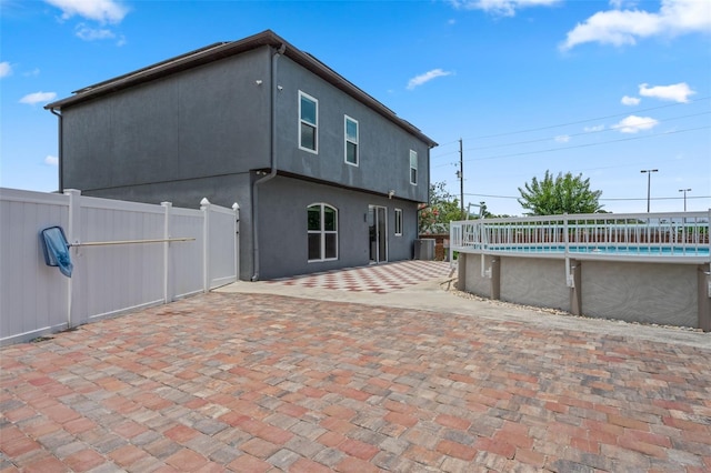 470 Regal Downs Cir, Winter Garden, FL 34787 - back of property featuring a patio, central air condition unit, and stucco siding