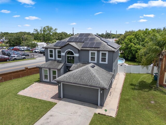 470 Regal Downs Cir, Winter Garden, FL 34787 - traditional-style home featuring an attached garage, stucco siding, driveway, solar panels, and roof with shingles
