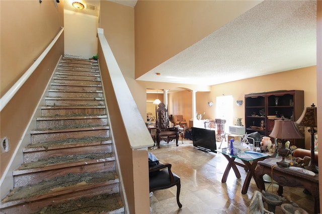 2305 Rio Grande Forest Ln, Kissimmee, FL 34759 - staircase with ornate columns and arched walkways