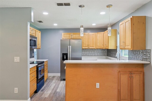 2704 Yule Tree Dr, Edgewater, FL 32141 - kitchen with appliances with stainless steel finishes, a peninsula, baseboards, light wood-style flooring, and tasteful backsplash