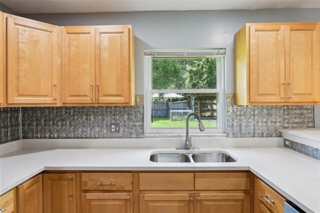2704 Yule Tree Dr, Edgewater, FL 32141 - kitchen featuring a sink, light countertops, tasteful backsplash, and stainless steel dishwasher