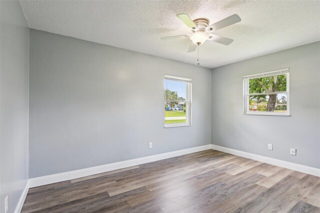 2704 Yule Tree Dr, Edgewater, FL 32141 - unfurnished room with wood finished floors, ceiling fan, a textured ceiling, and baseboards